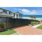 Finn sliding gate in black installed with matching fences at a seaside premium home - XGATE NZ