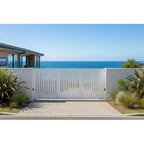 Vertical louvre-slat sliding gate in white installed at a seaside property - XGATE NZ