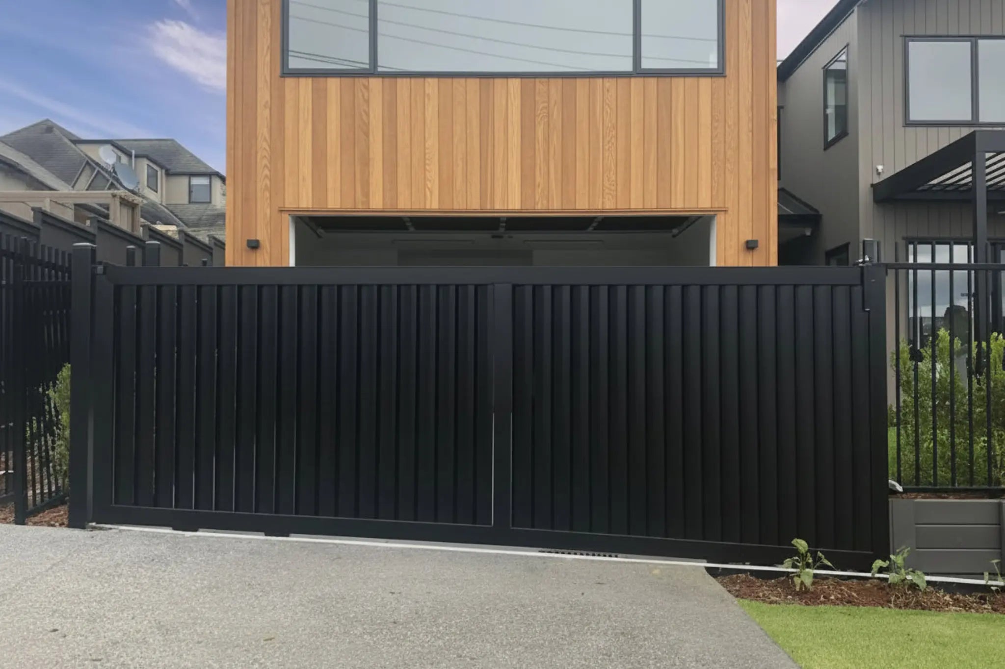Vertical louvre sliding gate in black installed - XGATE NZ